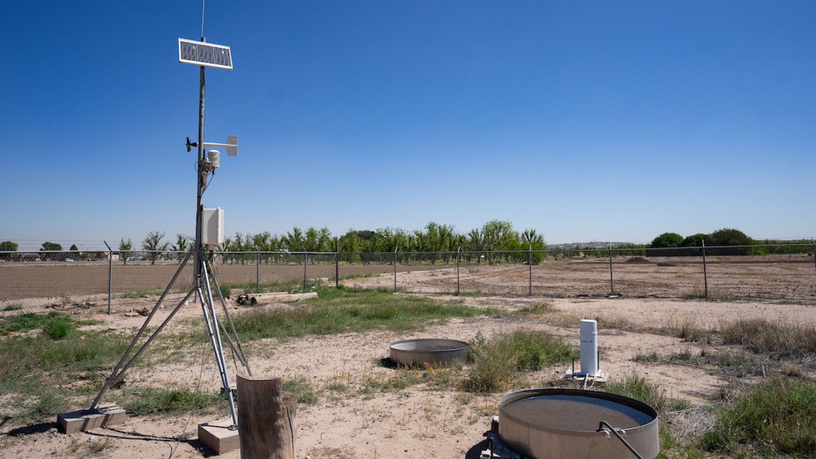 digital monitoring equipment on a dry patch of land with patches of wild grass around